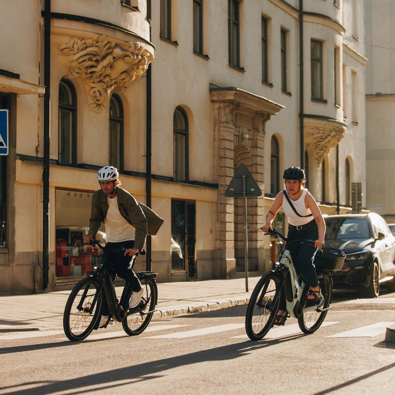 Zwei Personen fahren mit e-Bikes von Specialized durch die Stadt