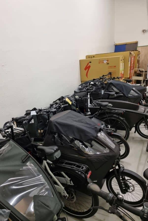 Mehrere Lastenfahrräder in Lagerraum mit Specialized Karton