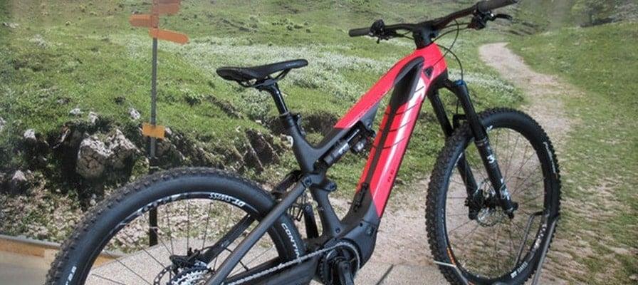 Rotes E-Mountainbike auf steinigem Pfad in Berglandschaft