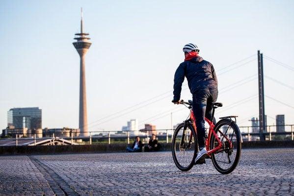 Person auf Specialized E-Bike fährt entlang einer Stadtlandschaft