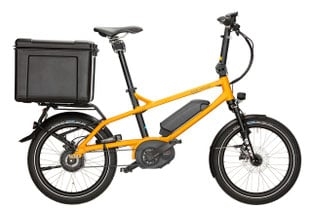 Gelbes E-Bike mit Gepäckbox auf dem Gepäckträger
